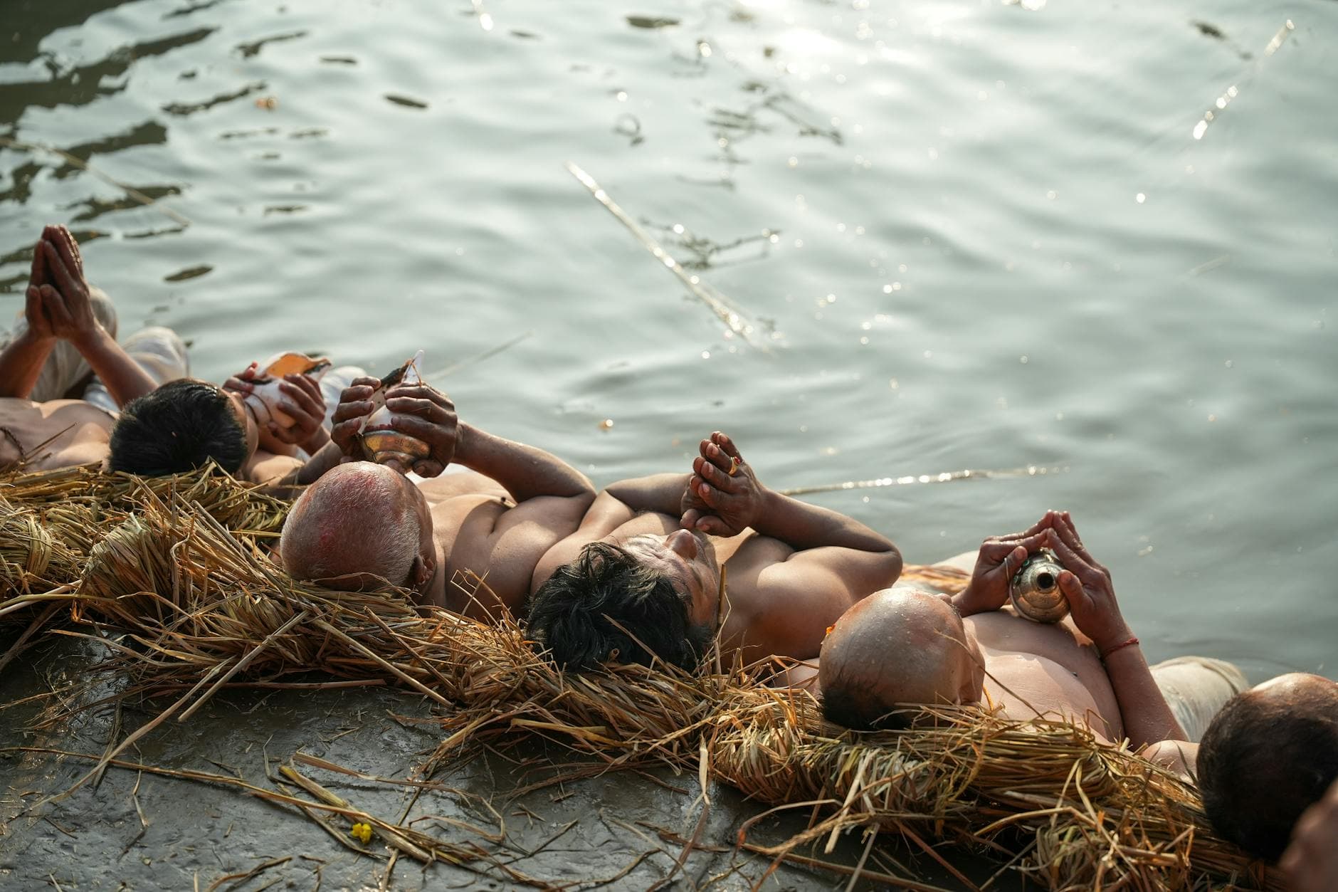 Devotees perform sacred rituals by the riverbank, symbolizing spiritual devotion.