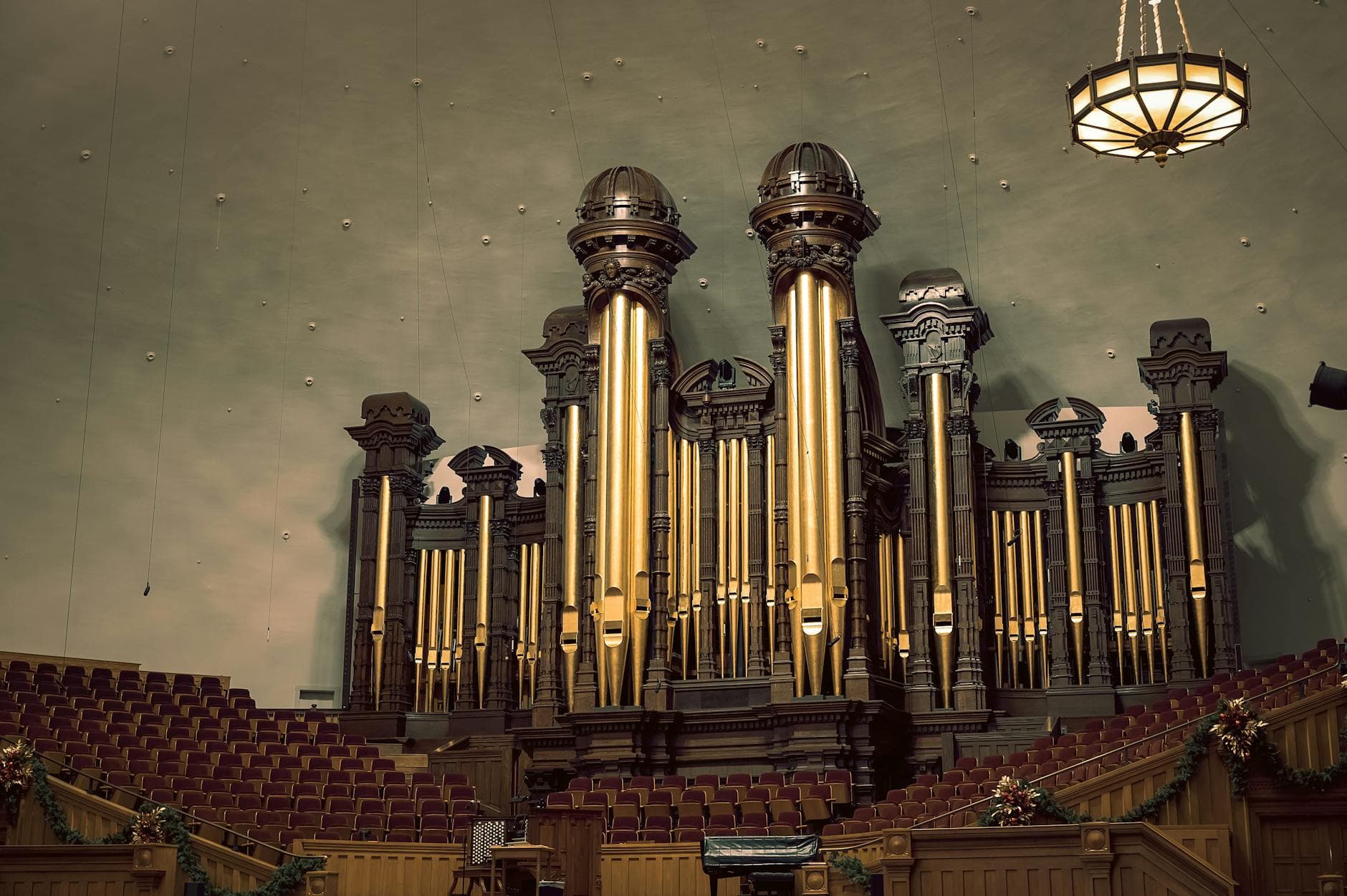 Majestic organ in an empty Salt Lake City Tabernacle, featuring ornate seating.